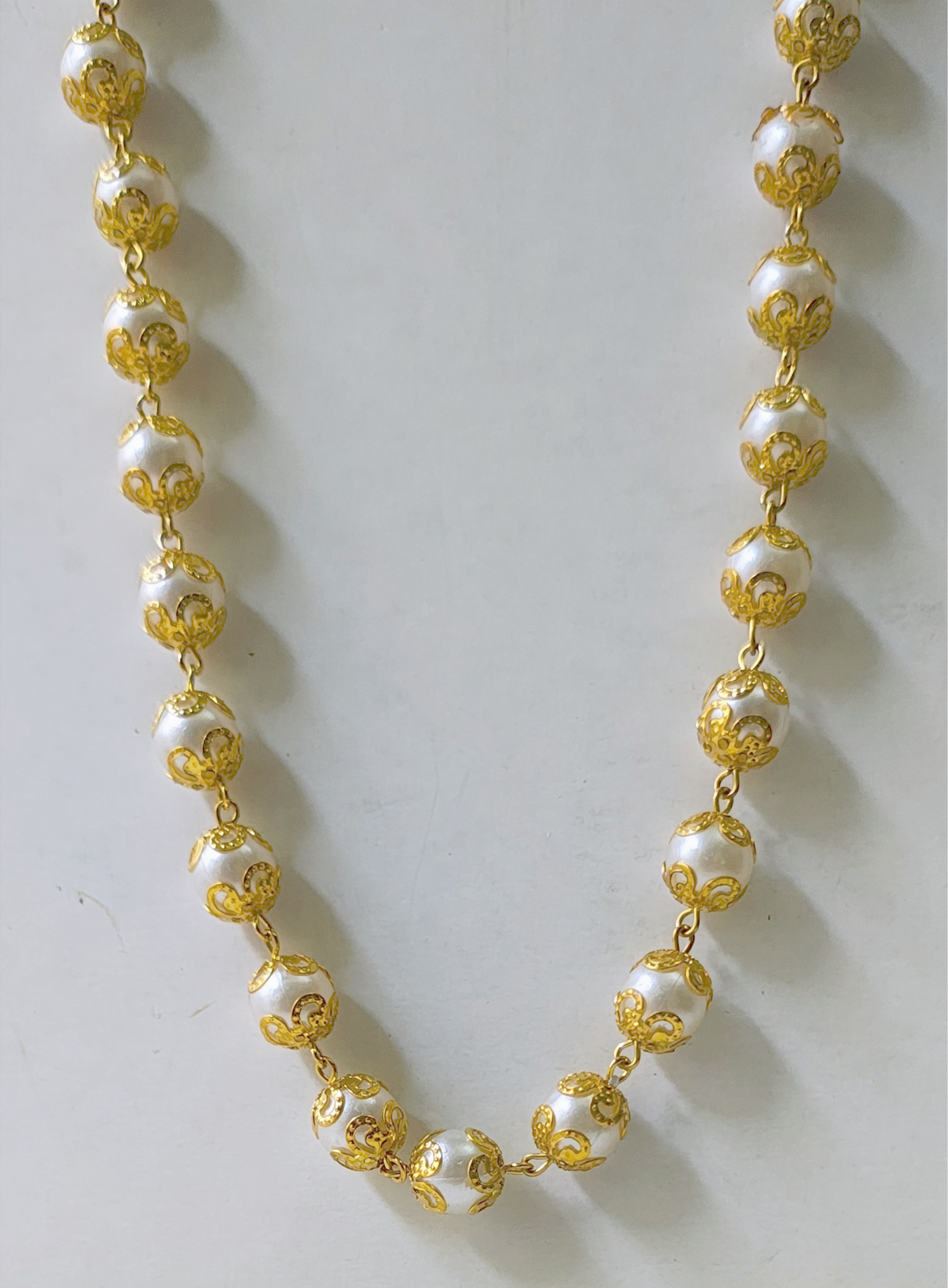 mango-toned necklace
sunset pearl necklace
bold festive accessories
resort jewellery india